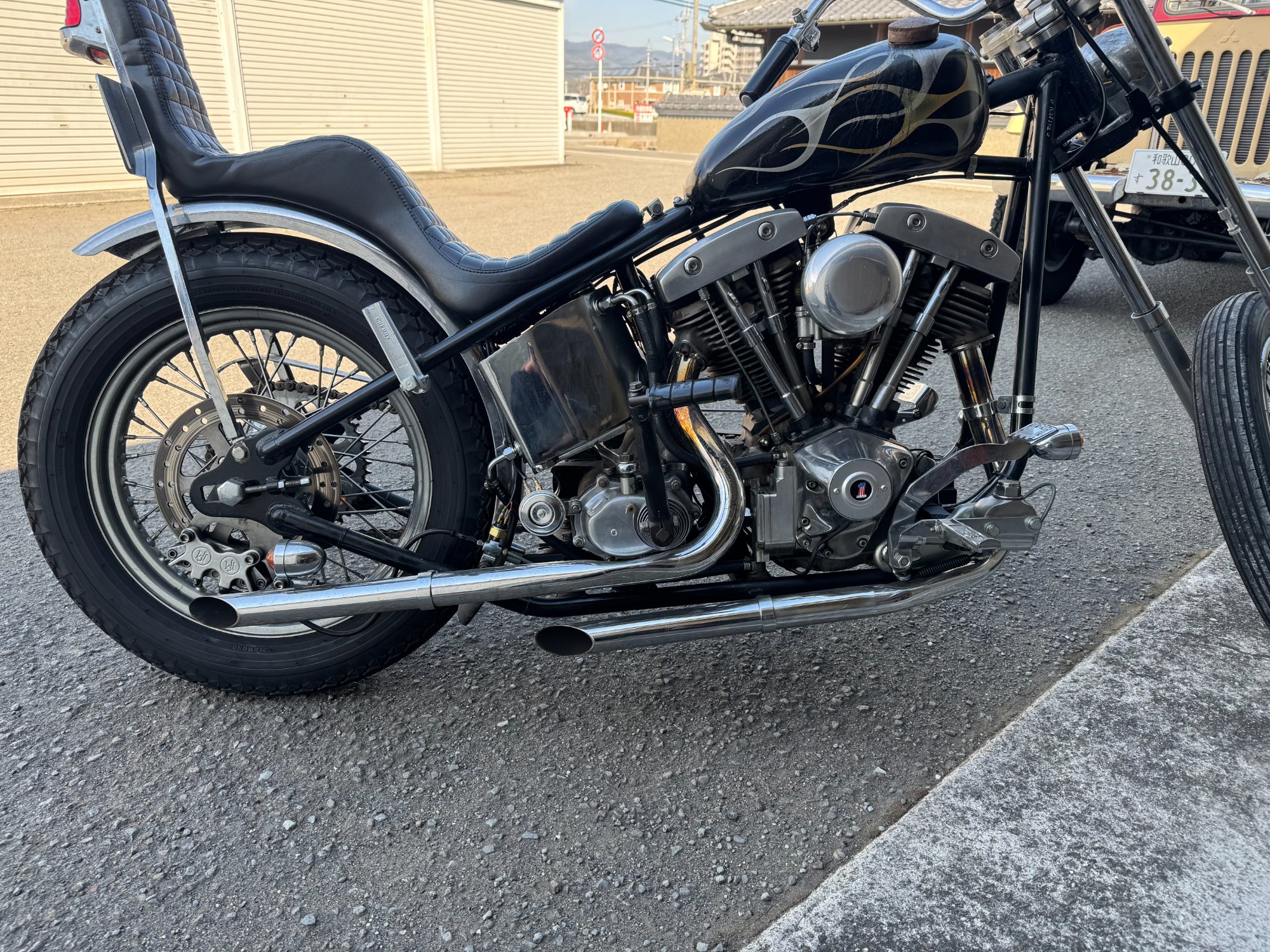 ショベルヘッド・チョッパーの右側。リジッドフレームに装着して折りたたんだ状態のDIXIE製アンダーソンタイプ・クランプステップ。